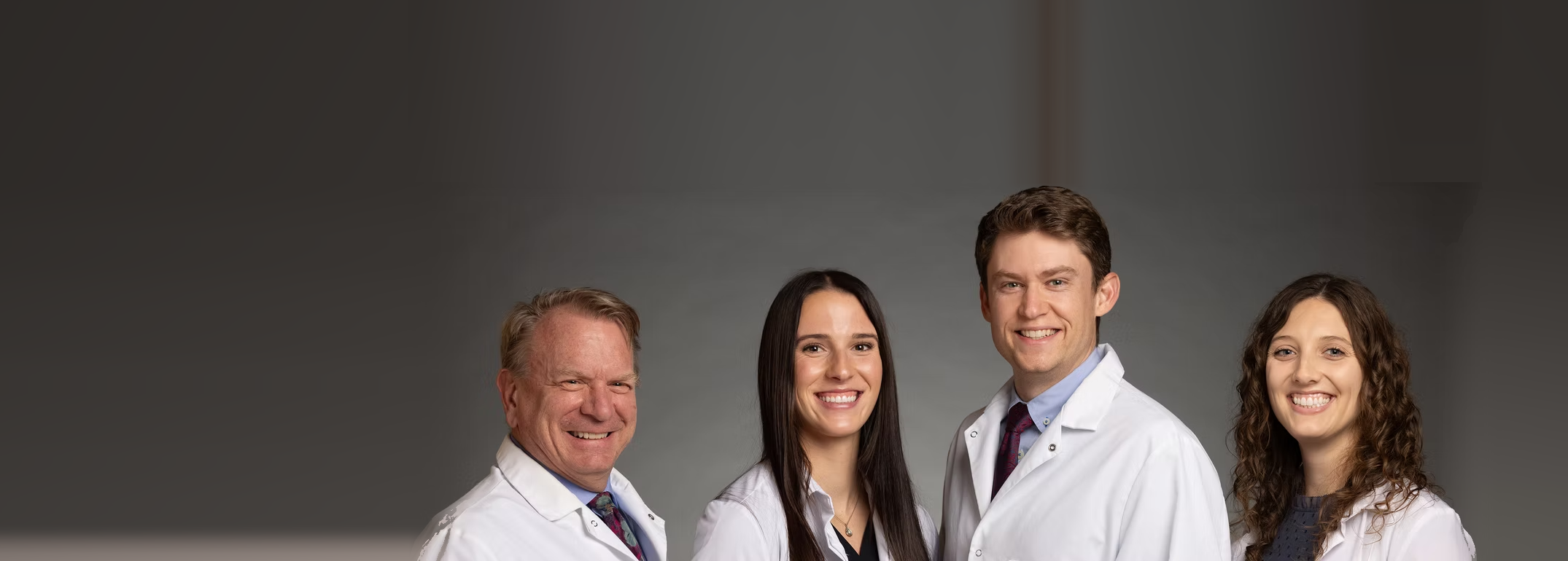 The four dentists of O'Kane & Monssen Family Dentistry — Dr. Monssen, Dr. Schley, Dr. Howley and Dr. Hanson — in St. Paul, MN